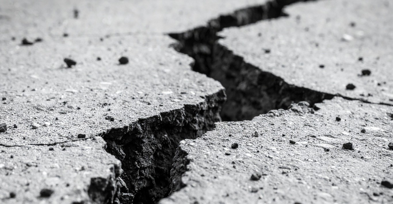 Cracked concrete surface being repaired by a professional contractor in Surprise, AZ
